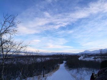 Scenic view of lake against sky during winter