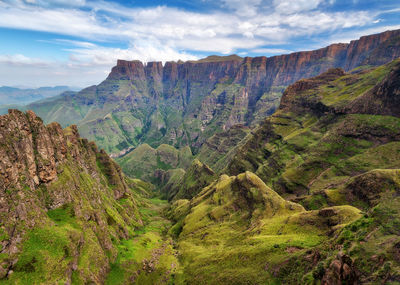 Scenic view of mountain range against cloudy sky