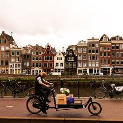 Side view of man riding cycle on street 