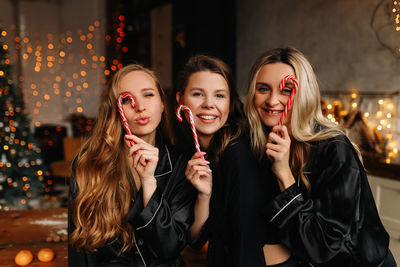 Happy funny girls celebrate christmas holidays and new year in a cozy house