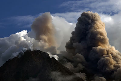 Low angle view of smoke stack against sky