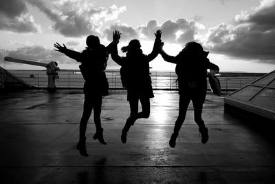 People enjoying in sea against sky