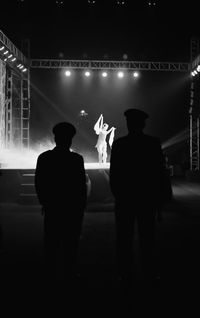 Rear view of silhouette man with illuminated lights