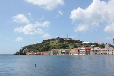 View of town by sea against sky