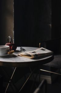 Close-up of food and drink with newspaper on table