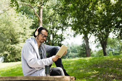 Young man sitting in park