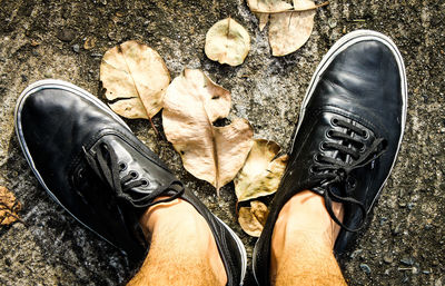 Low section of man standing on shoes