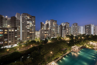 High angle view of residential buildings in city at night