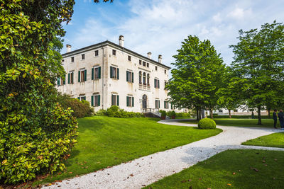 Lawn by building against sky