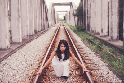 Portrait of woman on railroad track
