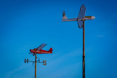 Low angle view of street light against blue sky