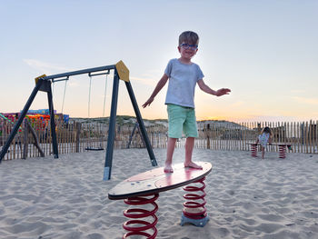 Full length of man standing on slide at beach
