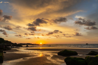 Scenic view of beach against sky during sunset