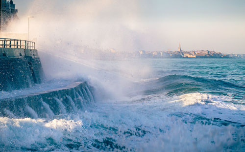 High tide and splashing wave in saint malo, brittany, france