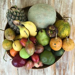 Directly above shot of various fruits in container on table