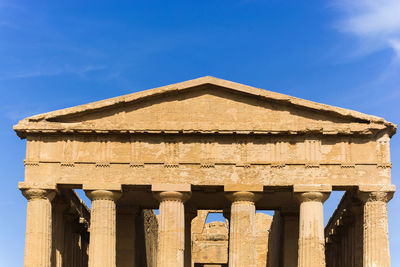 Low angle view of historical building against blue sky