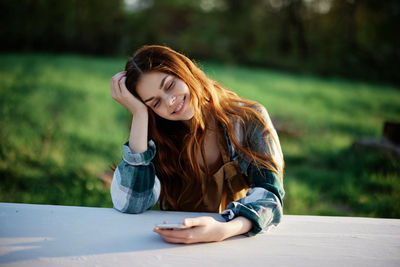 Young woman sitting on table