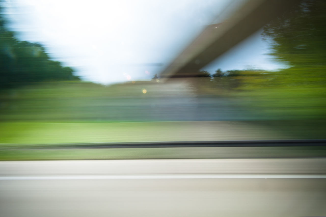 BLURRED MOTION OF CAR MOVING ON ROAD