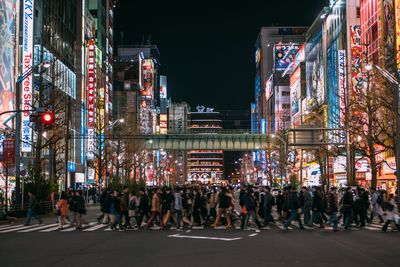 Crowd on illuminated city at night