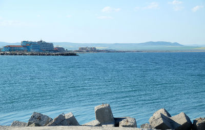 Panoramic view of sea and buildings against sky