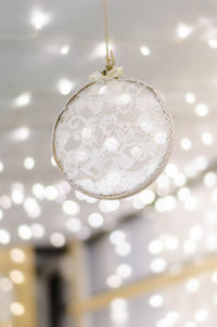 Low angle view of illuminated pendant light hanging from ceiling