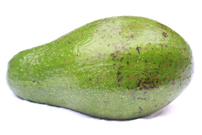 Close-up of green fruit against white background