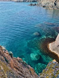 High angle view of rocks in sea