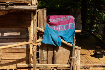 Cloth drying on wooden fence in sunlight