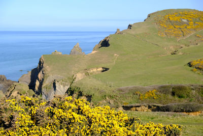 Scenic view of sea and mountains against sky