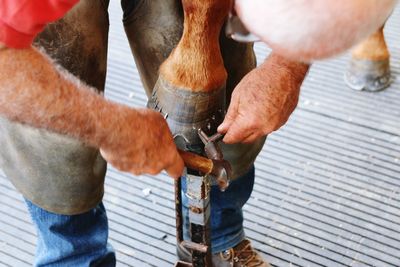 High angle view of man working on metal