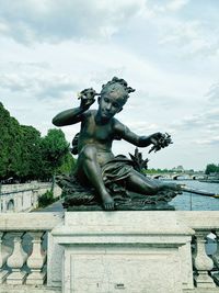 Low angle view of statue against sky