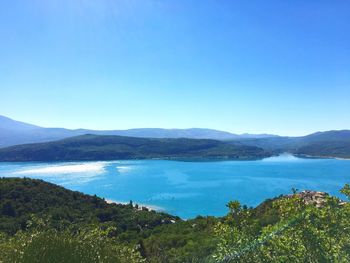 Scenic view of mountains against blue sky