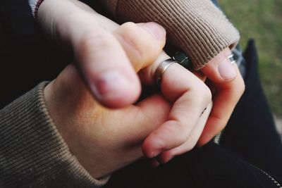 Close-up of couple holding hands outdoor