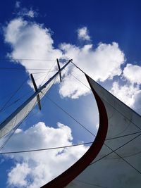 Low angle view of power lines against blue sky