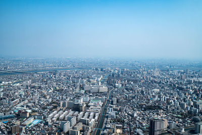 High angle view of city against blue sky