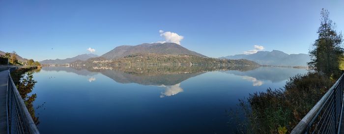 Panoramic view of lake and mountains against blue sky