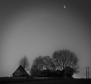 House on field against clear sky