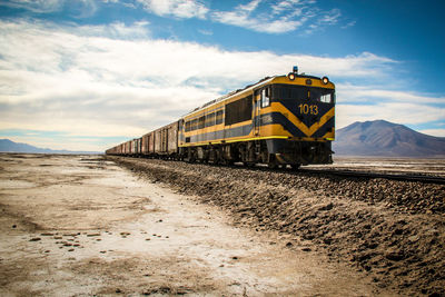Train on railroad track against sky