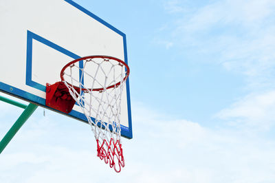 Low angle view of basketball hoop against blue sky