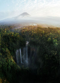 Scenic view of waterfall against sky