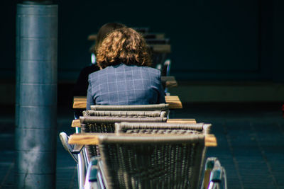 Rear view of boy sitting on stage