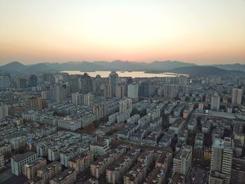 High angle view of cityscape against sky during sunset