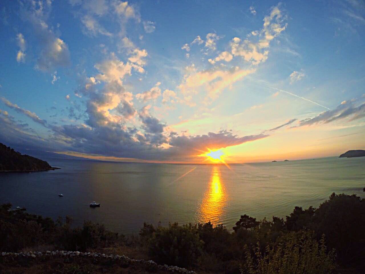 water, sunset, sea, scenics, tranquil scene, tranquility, horizon over water, beauty in nature, idyllic, sky, sun, nature, calm, ocean, coastline, remote, solitude, non-urban scene, blue, cloud - sky, cloud, shore, outdoors, lens flare, no people, seascape, majestic, tourism