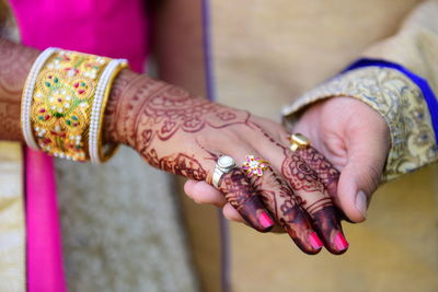 Midsection of woman with tattoo on hand