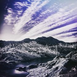 Scenic view of snow covered mountains against sky