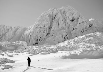 Full length of person on snowcapped mountain against sky