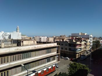 High angle view of buildings against clear blue sky