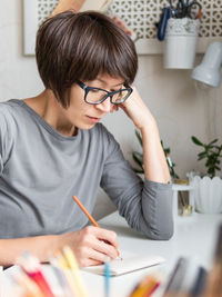 Midsection of woman using smart phone at home