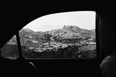 Scenic view of mountains seen through car window