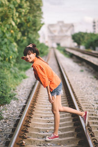 Side view of boy on railroad track